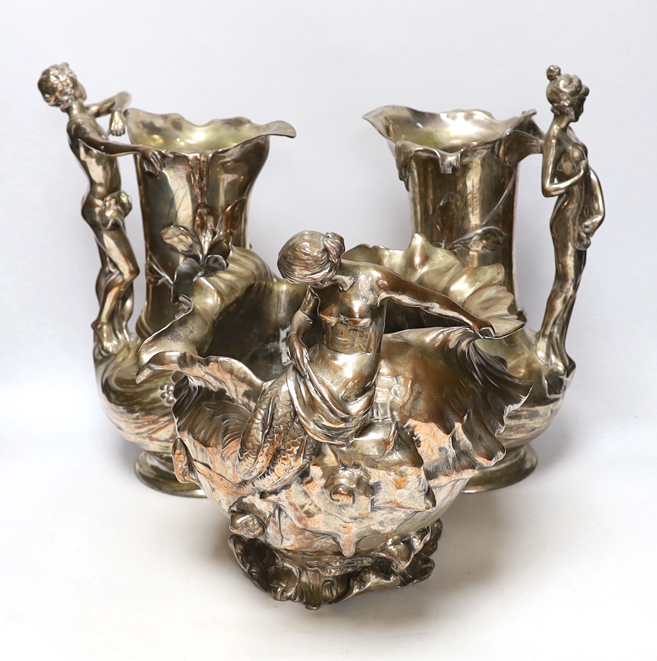 A pair of WMF Art Nouveau electroplated figural jugs and a similar mermaid jardiniere, unmarked, largest 35cm high
